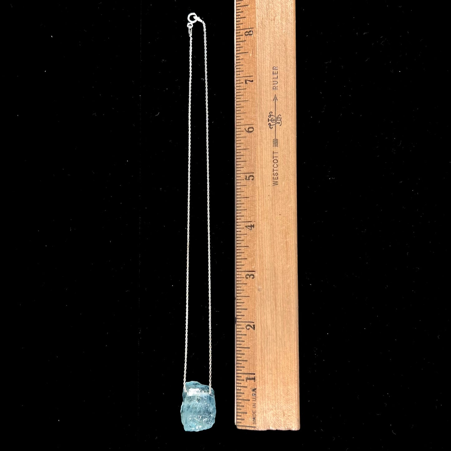 A drilled aquamarine crystal necklace on a silver wheat chain.