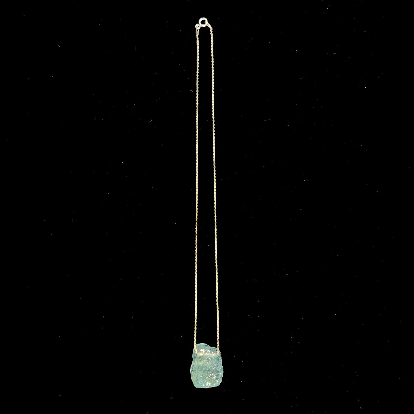 A drilled aquamarine crystal necklace on a silver wheat chain.