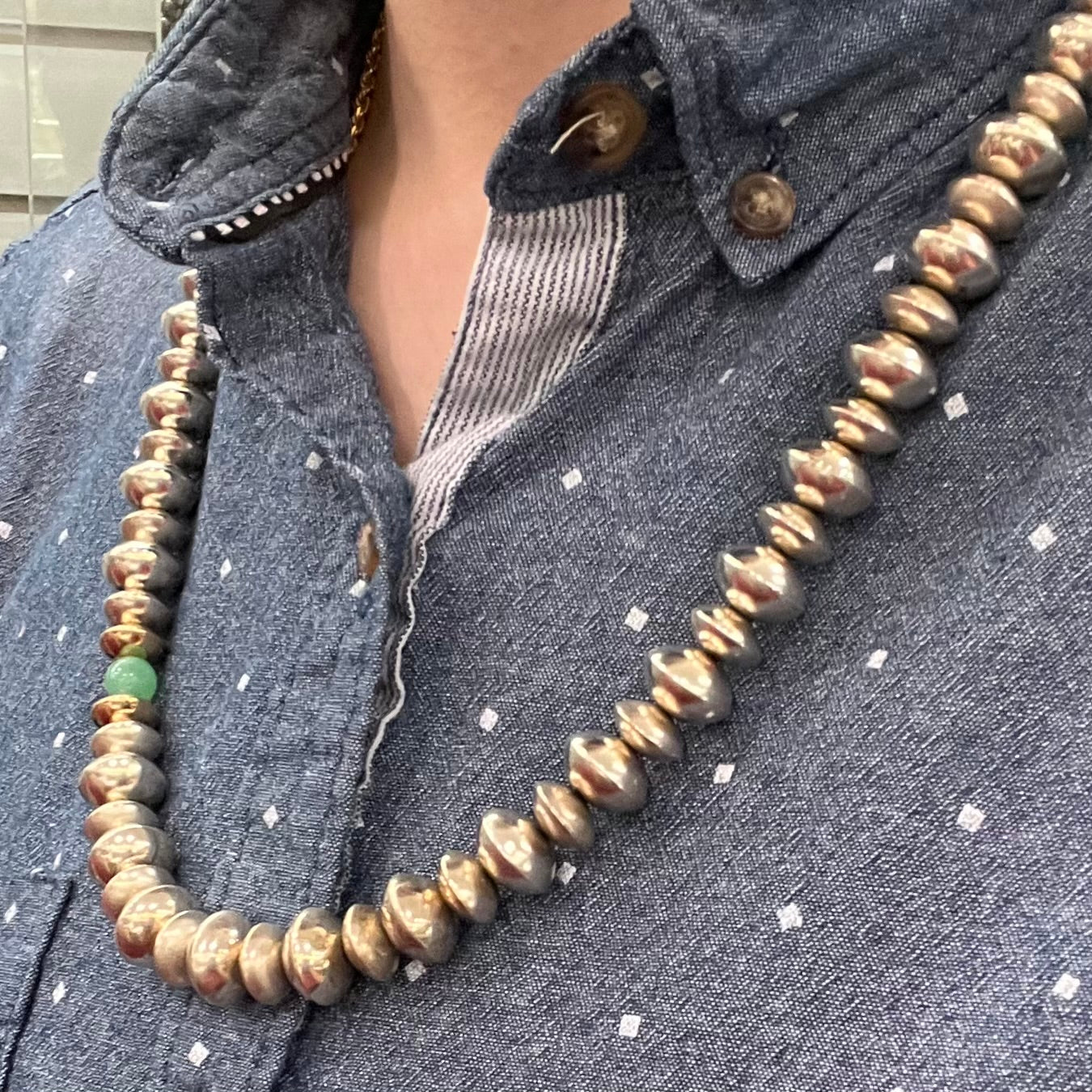 A silver, gold, and chrysoprase bead necklace handmade by Navajo artist, Alfred Joe.
