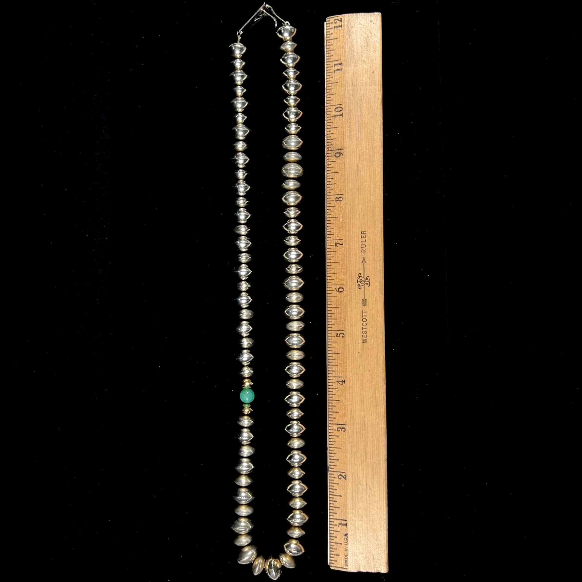 A silver, gold, and chrysoprase bead necklace handmade by Navajo artist, Alfred Joe.