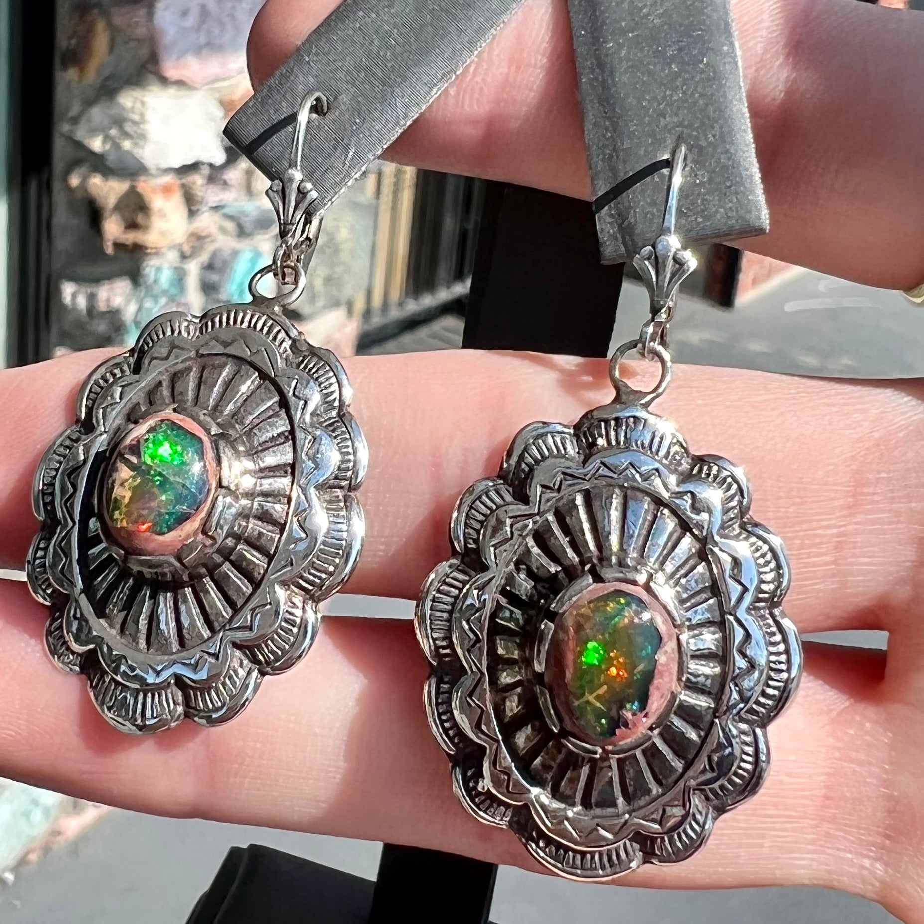 A pair of handmade sterling silver cantera opal earrings.  The earrings are Navajo style by artist Sam Yah.