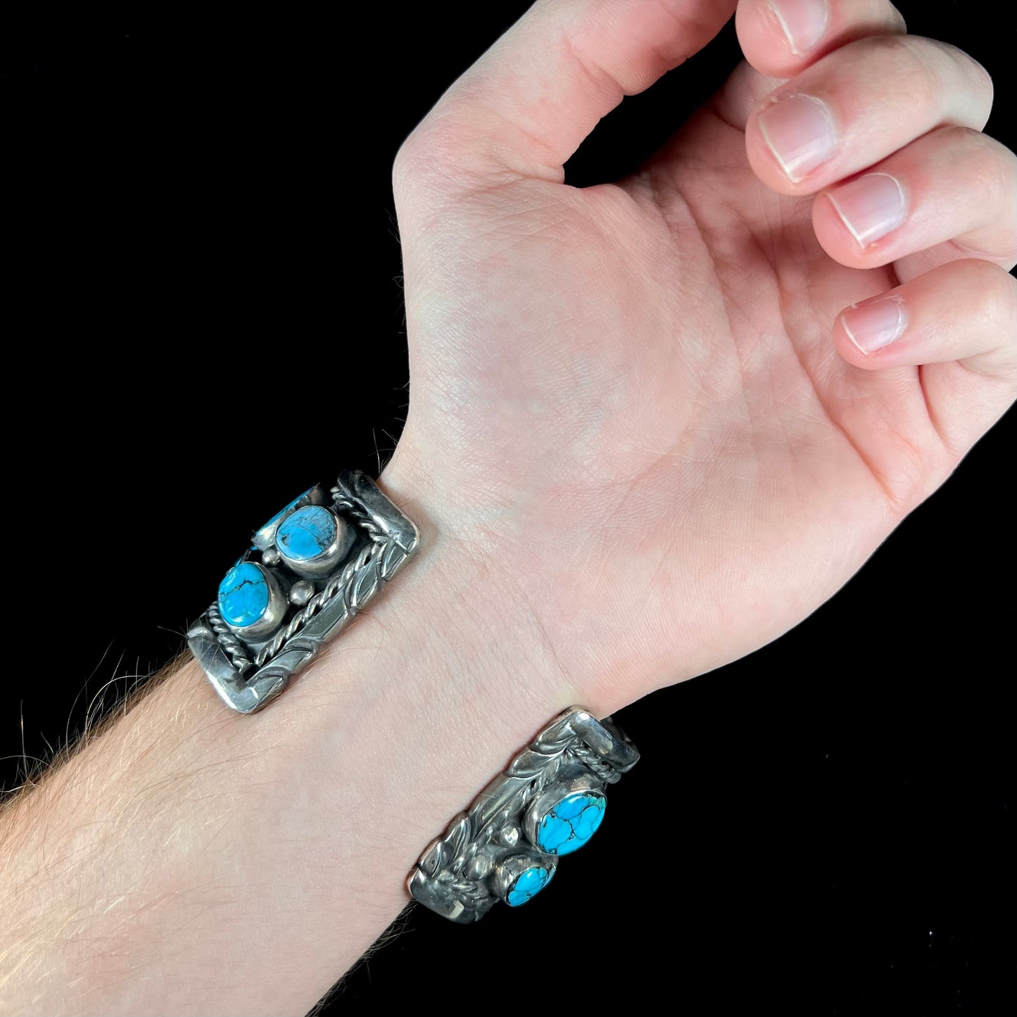 A men's sterling silver cuff bracelet bezel set with natural and synthetic turquoise stones.