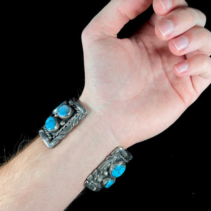 A men's sterling silver cuff bracelet bezel set with natural and synthetic turquoise stones.