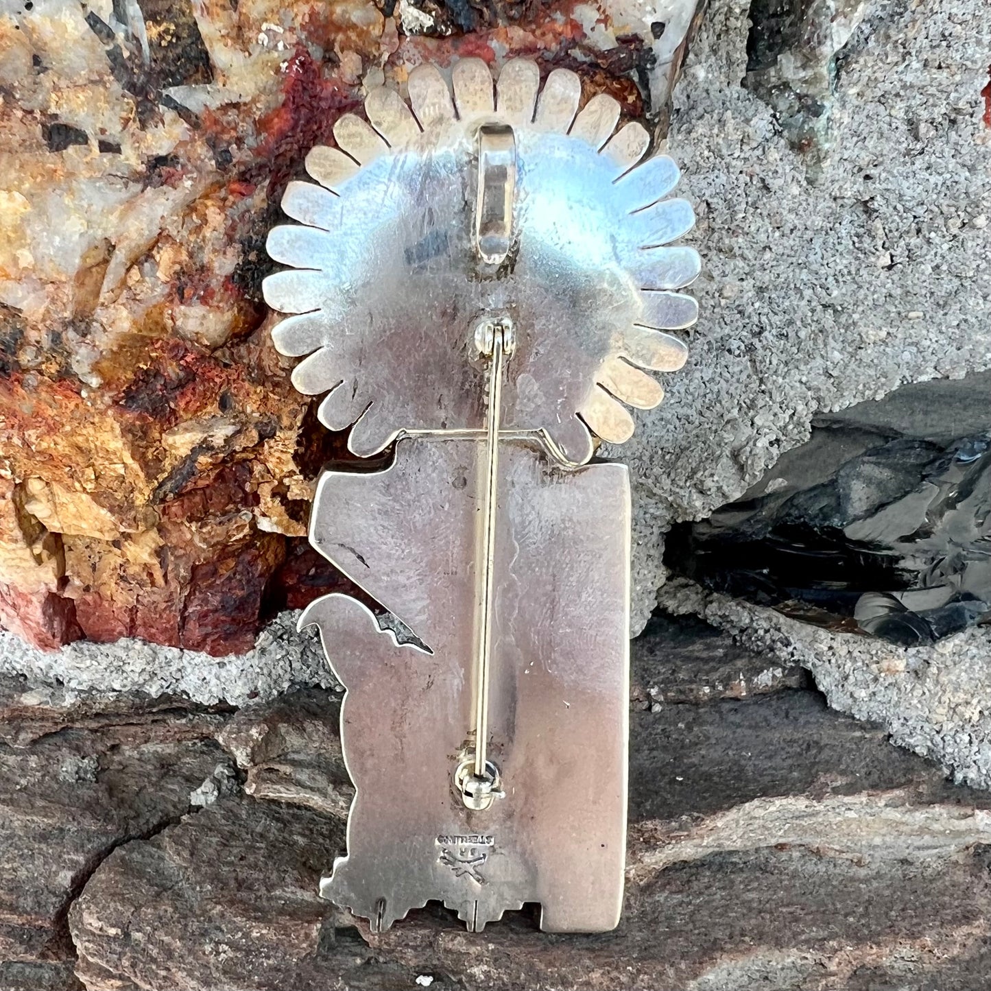 A Morning Singer kachina doll pendant made from sterling silver by Navajo artist Bennie Ration.