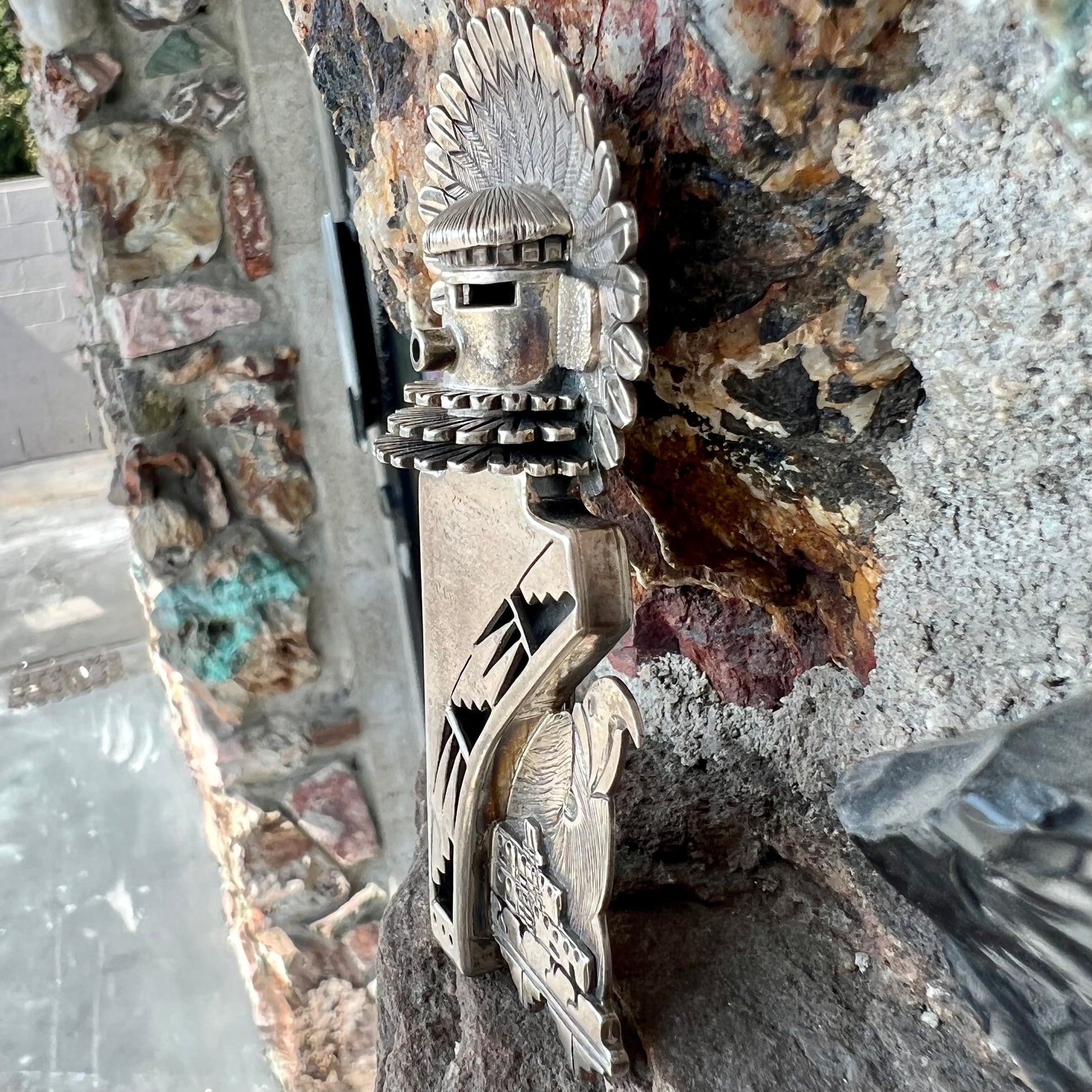 A Morning Singer kachina doll pendant made from sterling silver by Navajo artist Bennie Ration.