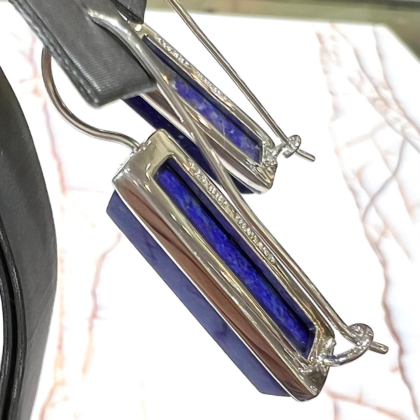 Rectangular cut lapis lazuli stones bezel set in sterling silver wire earrings.