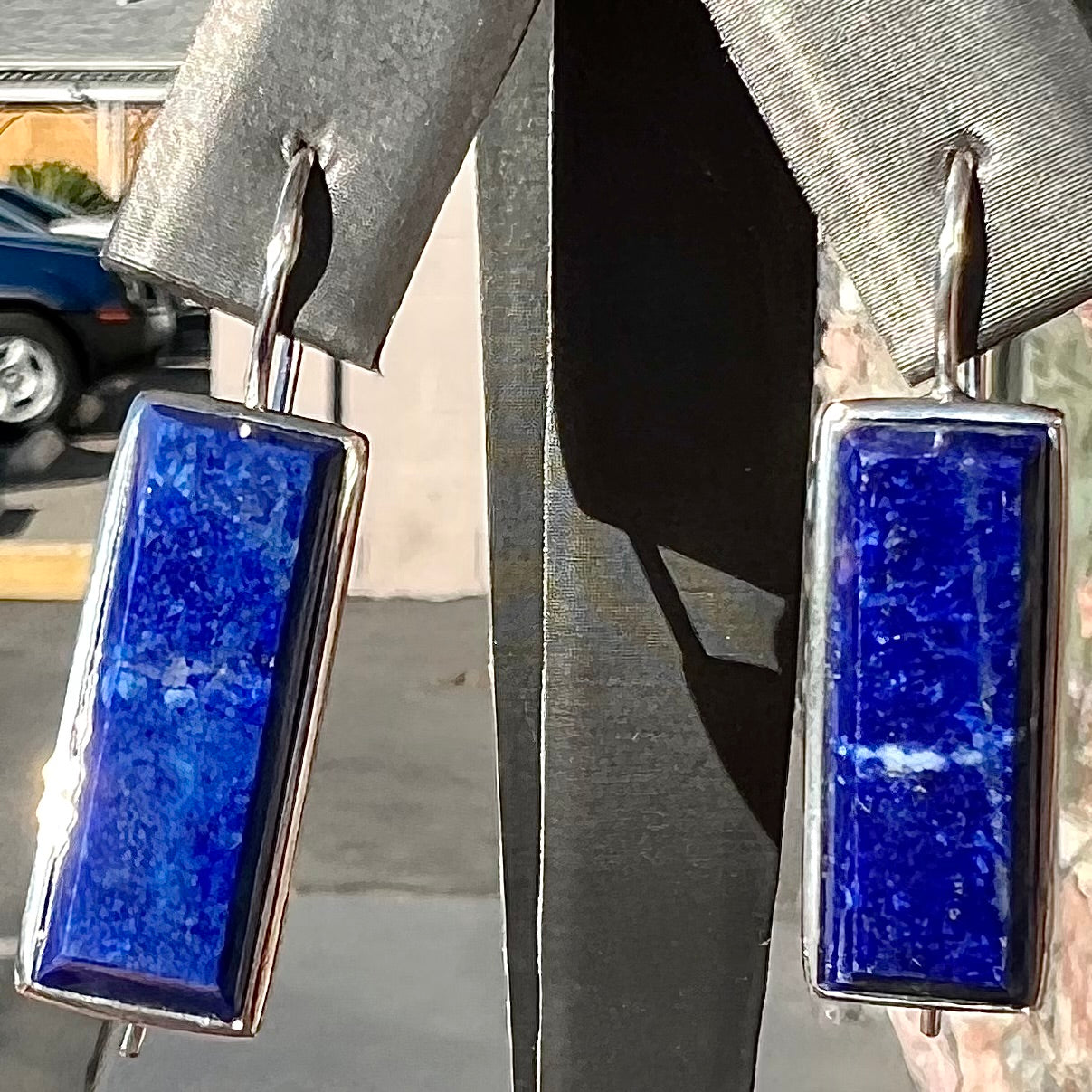 Rectangular cut lapis lazuli stones bezel set in sterling silver wire earrings.