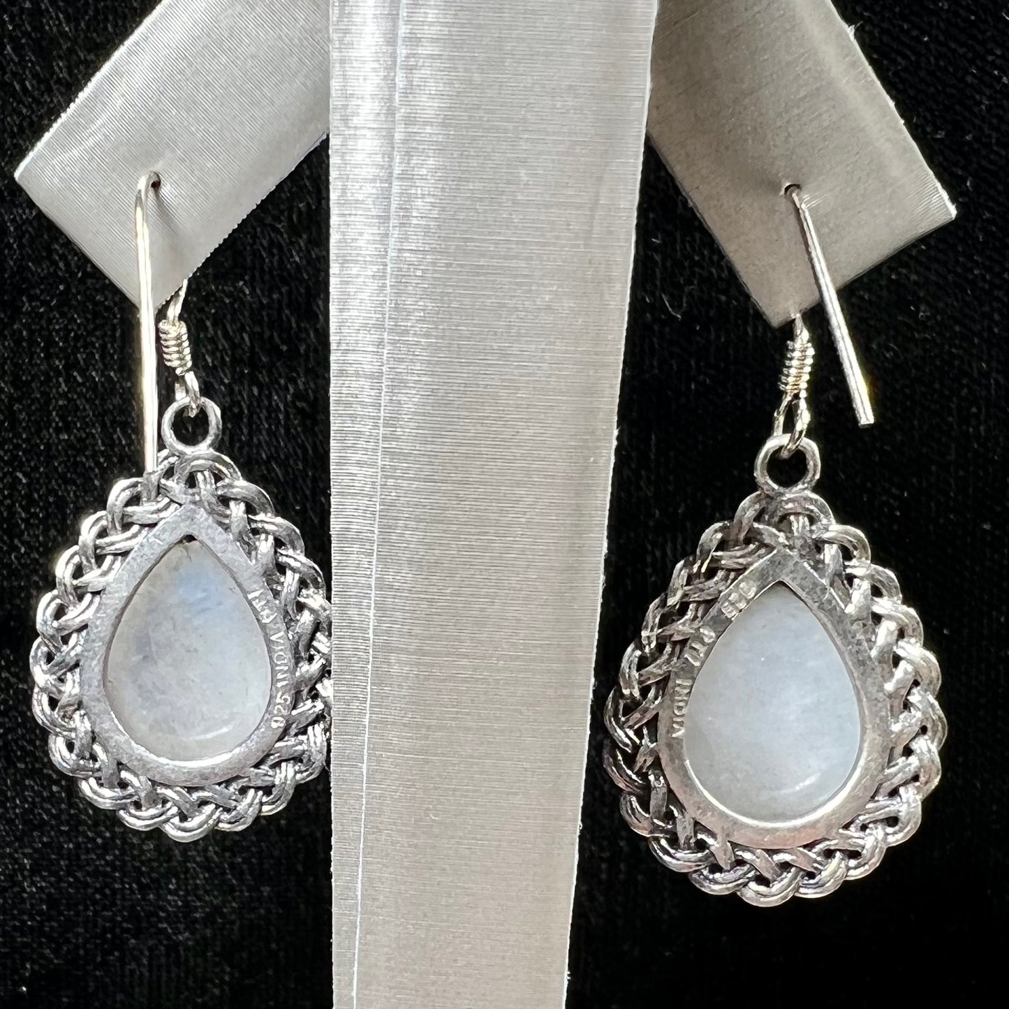 Silver filigree dangle wire earrings set with pear shape moonstones.