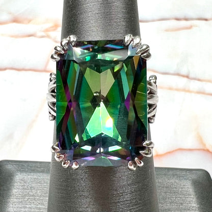 Emerald cut mystic topaz prong set in a decorative sterling silver ring.