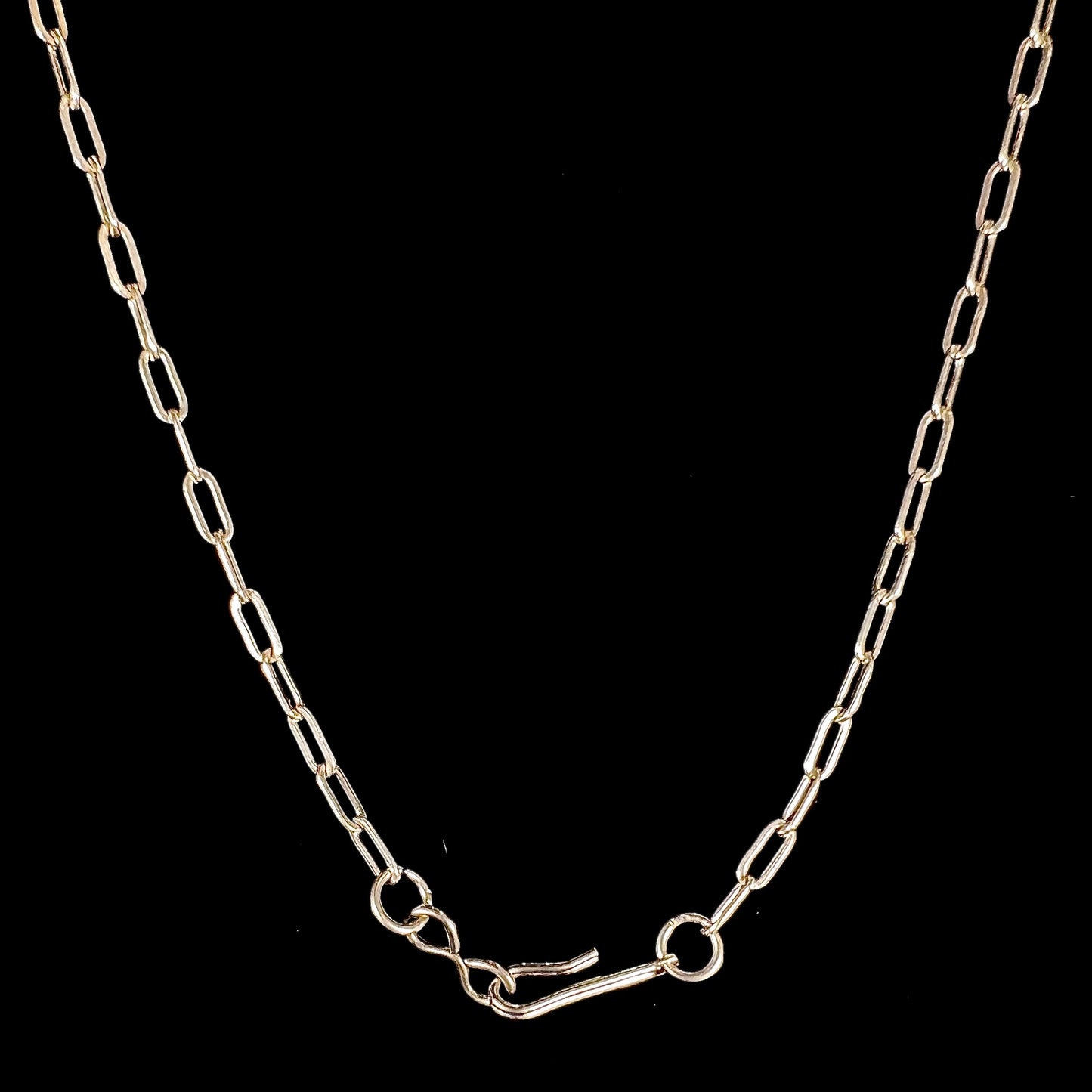 A silver turquoise necklace handmade with nine silver bear paws set with round turquoise stones.