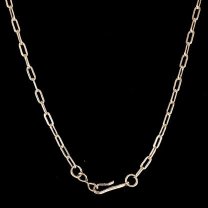 A silver turquoise necklace handmade with nine silver bear paws set with round turquoise stones.
