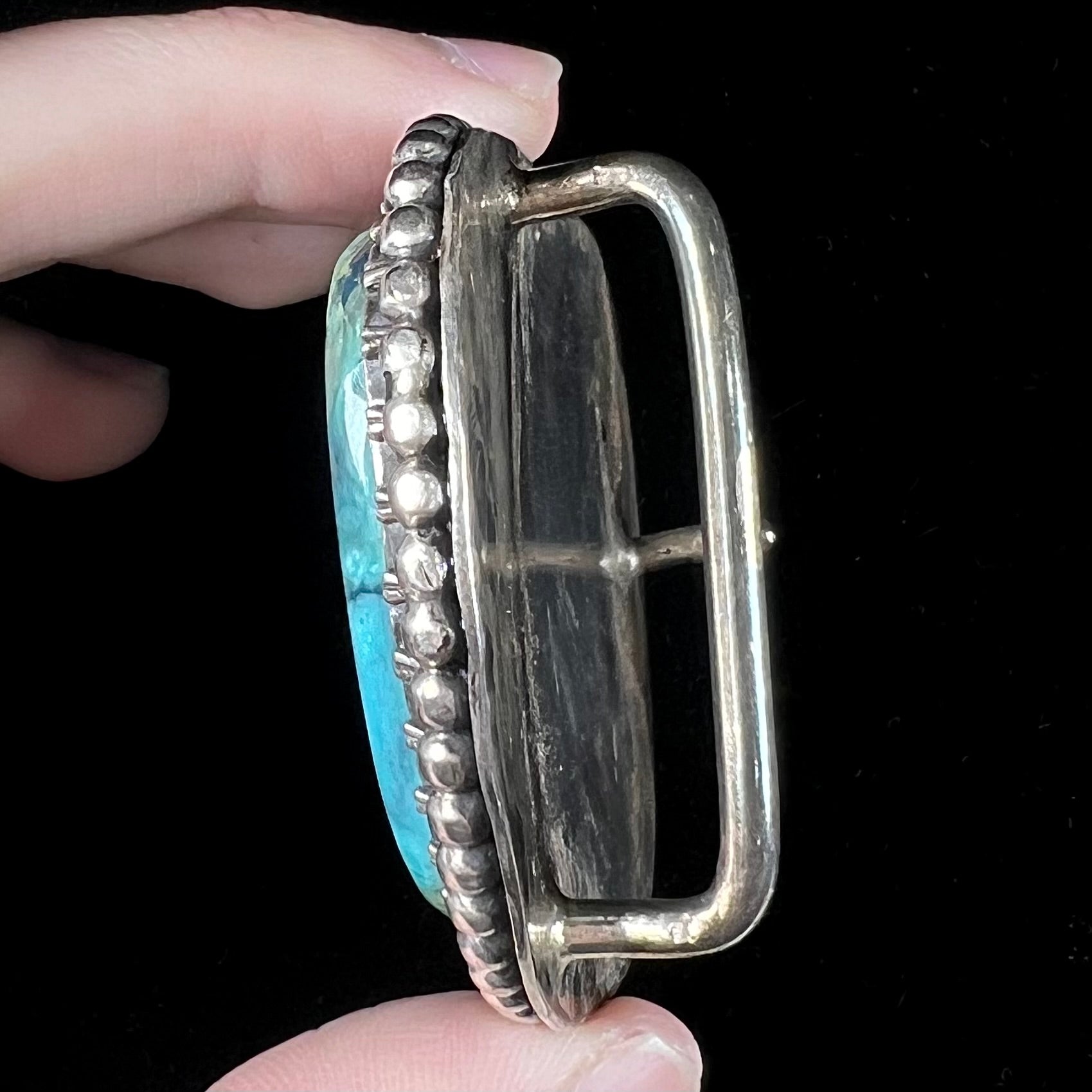 A sterling silver, unisex, Navajo style belt buckle set with a large Valley Blue turquoise stone.