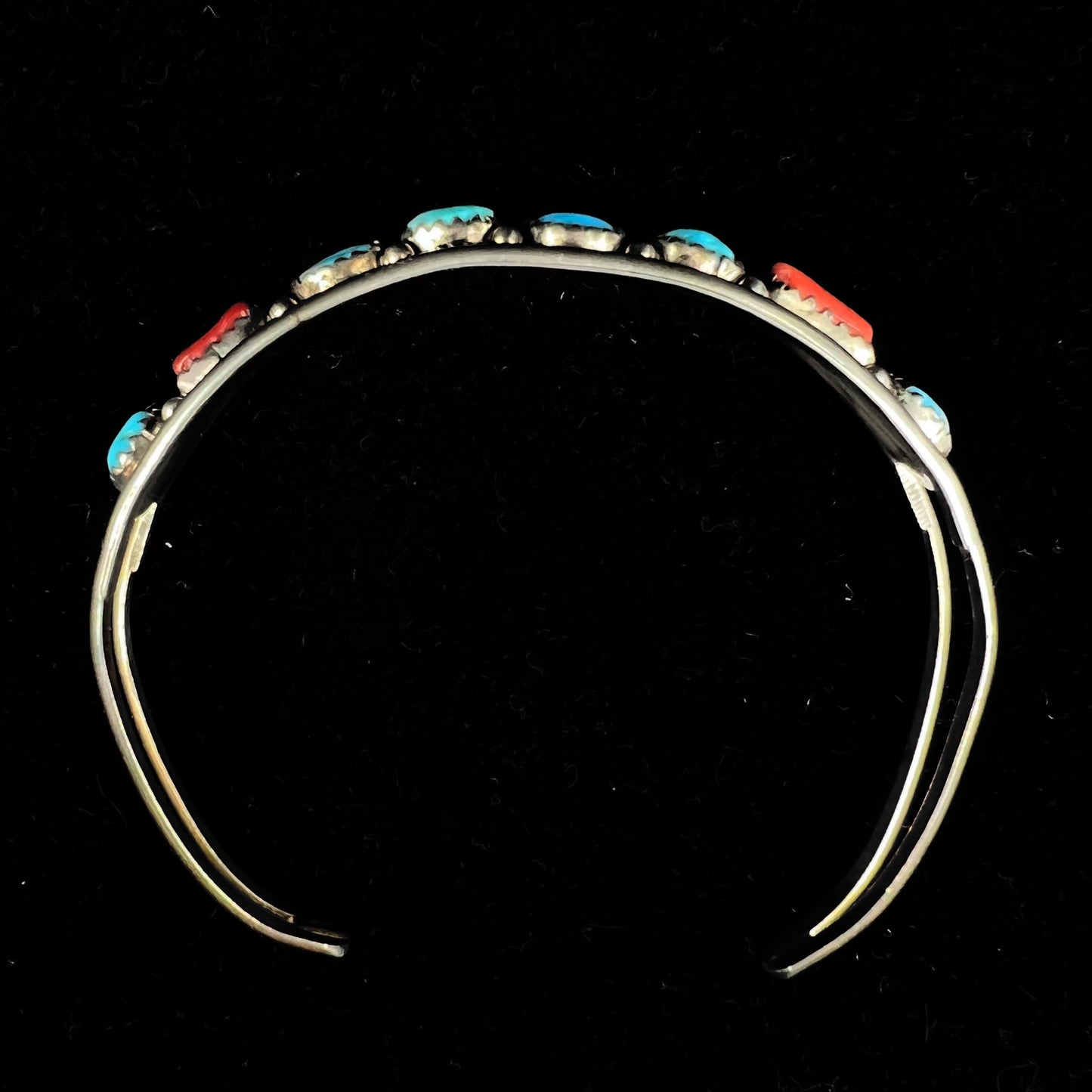 A silver ladies' turquoise and coral cuff bracelet, handmade by Navajo artist, John Delvin.