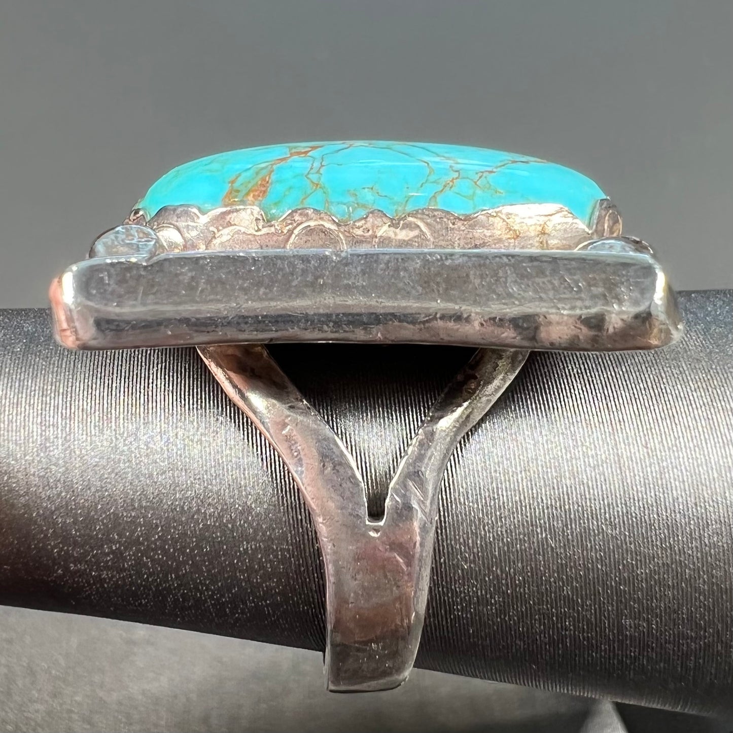 A sterling silver ring set with Tyrone turquoise from Burro Mountains, New Mexico.