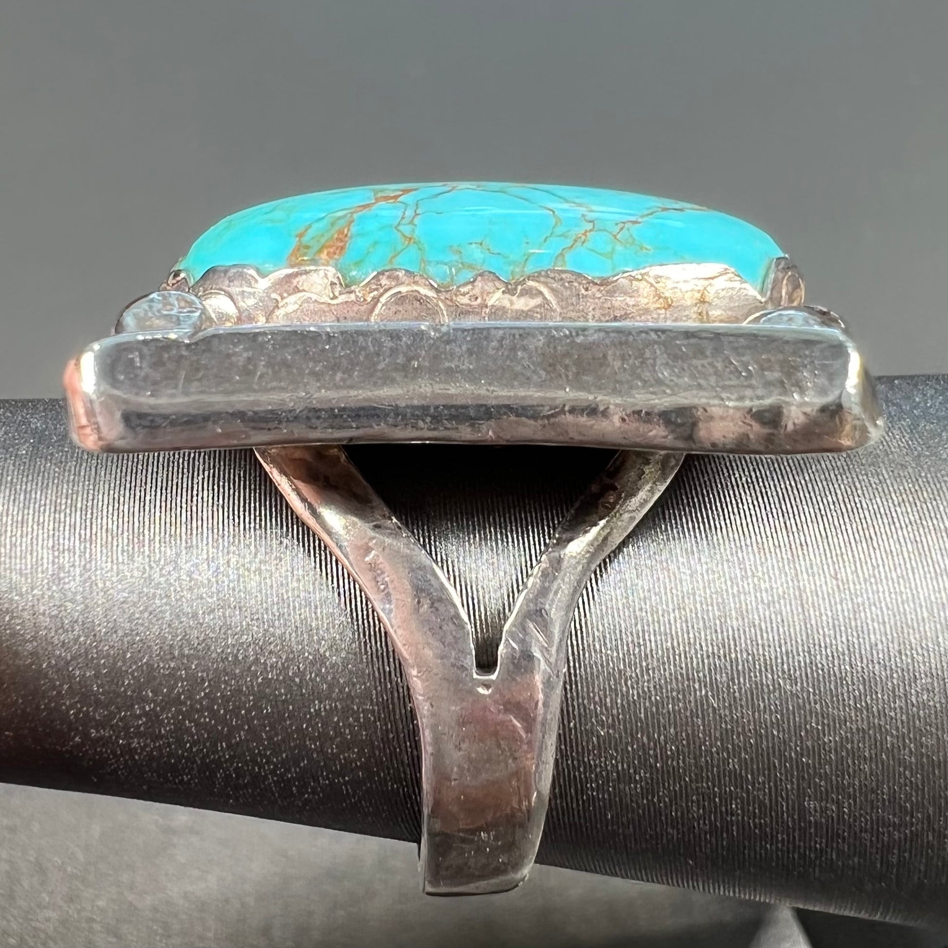 A sterling silver ring set with Tyrone turquoise from Burro Mountains, New Mexico.
