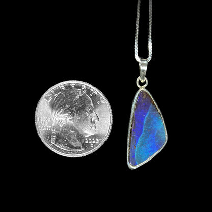 A ladies' sterling silver necklace bezel set with a triangle drop shaped Australian black boulder opal.