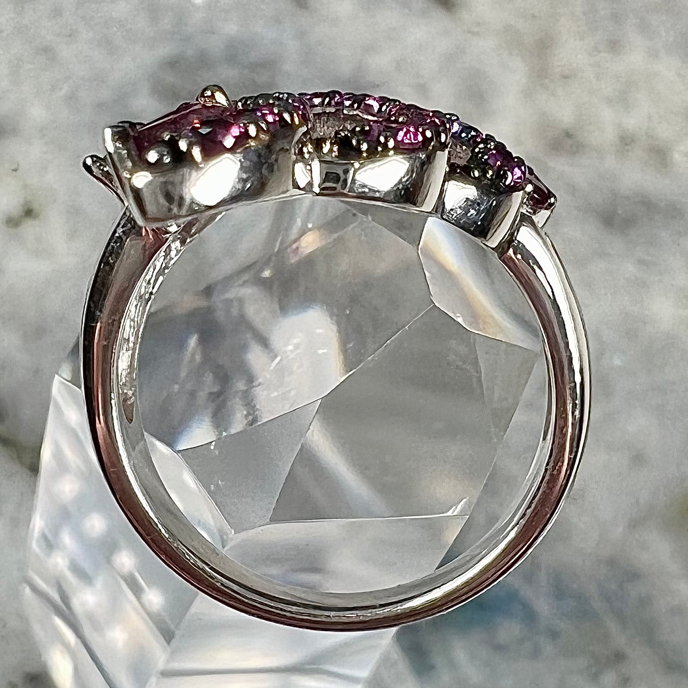 A sterling silver, feather shaped ring set with round and marquise cut rhodolite garnet stones.