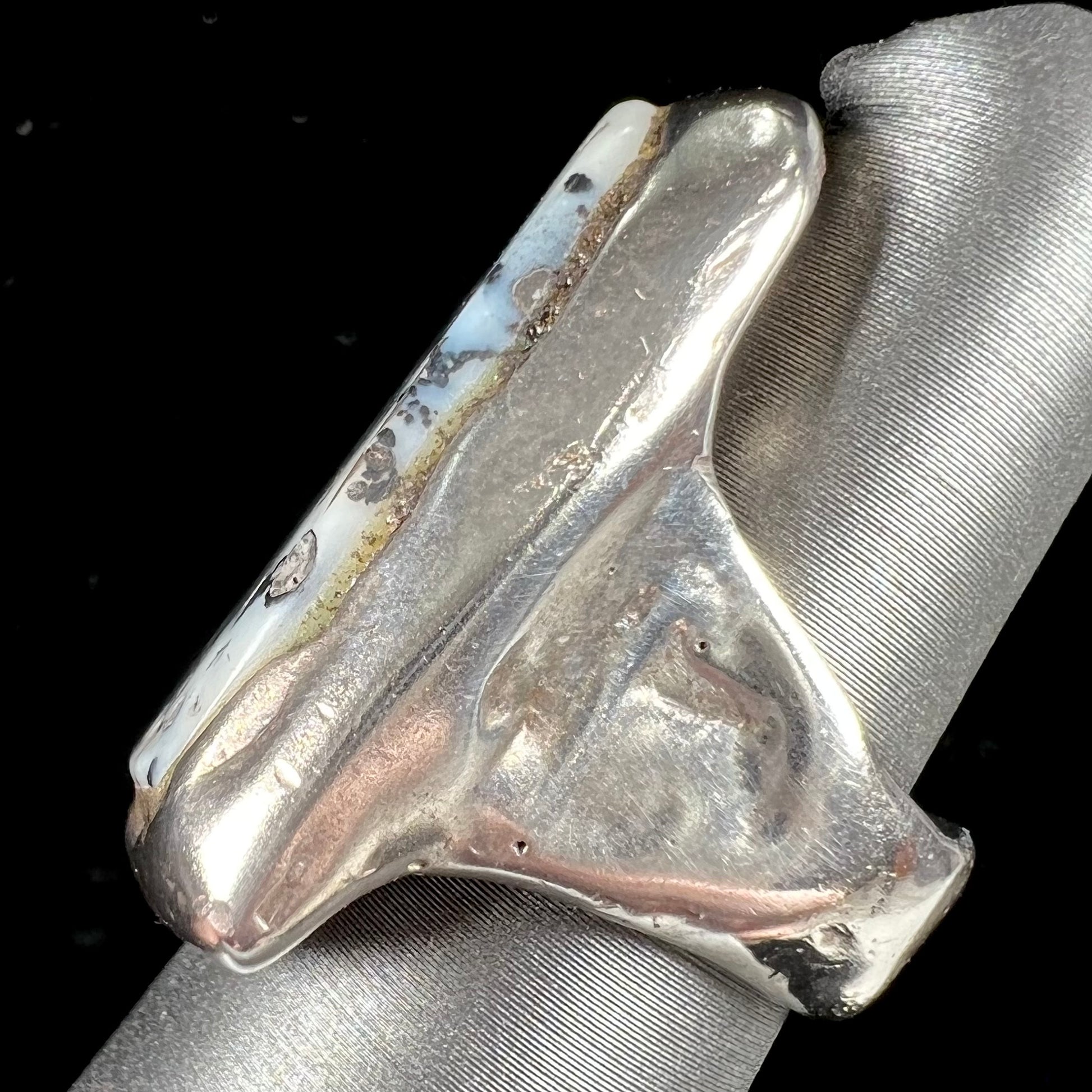 A bezel set ring handmade in sterling silver with a white dendritic agate stone.