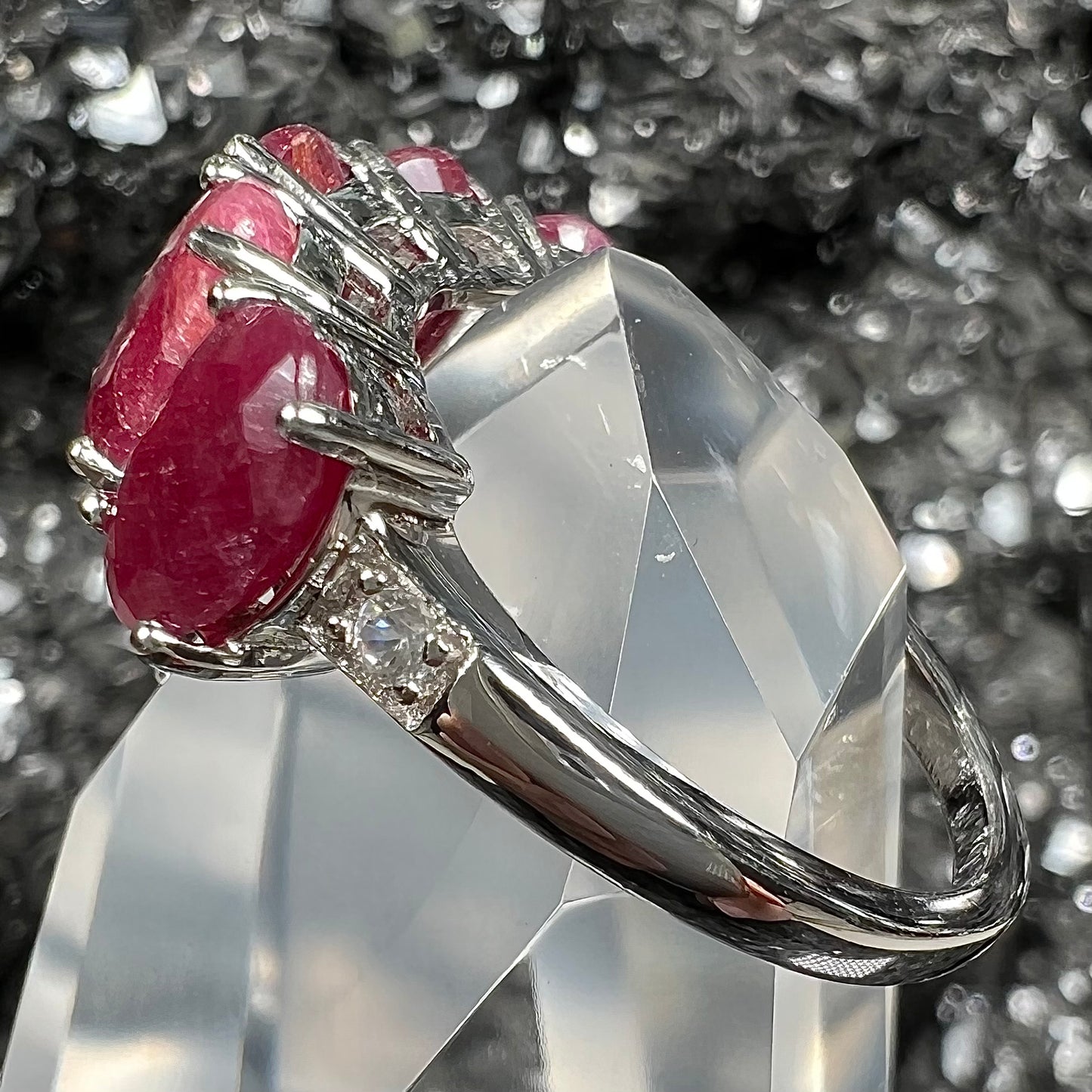 A sterling silver, five stone, faceted oval cut red ruby stackable ring.