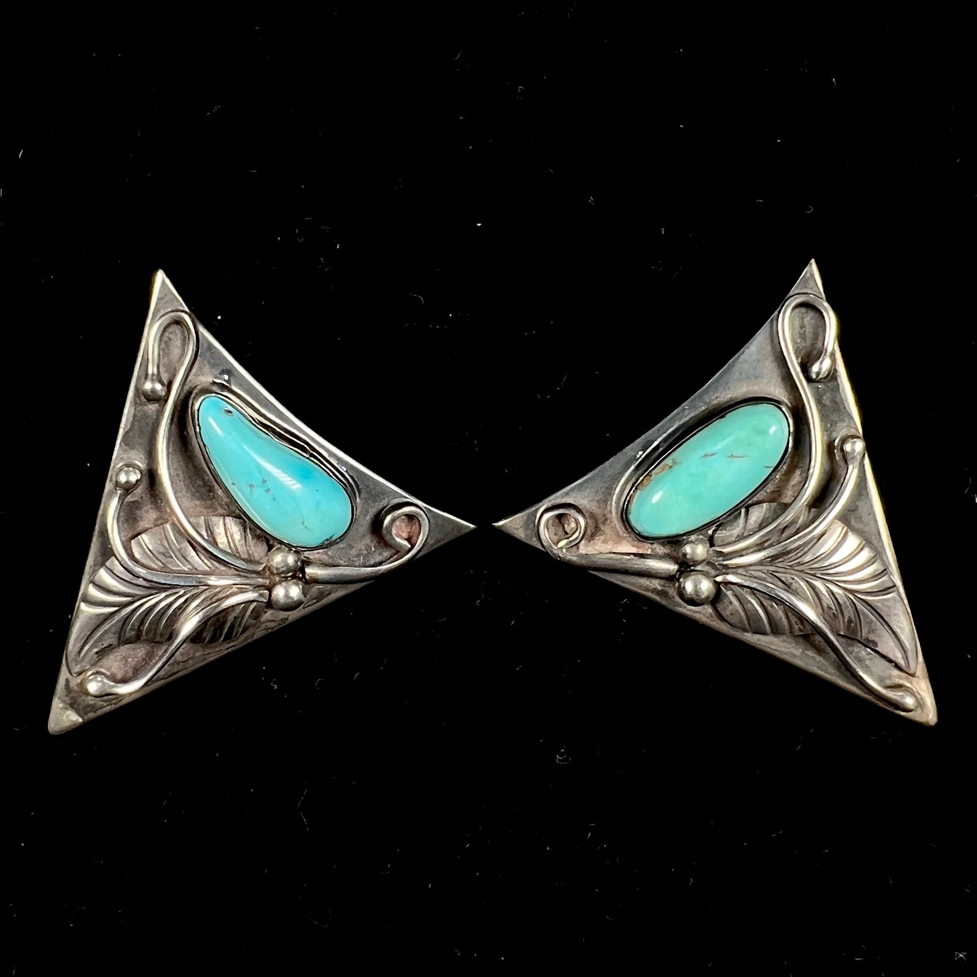 A pair of sterling silver and turquoise shirt collar tips handmade by Navajo artist, Phillip Guerro.