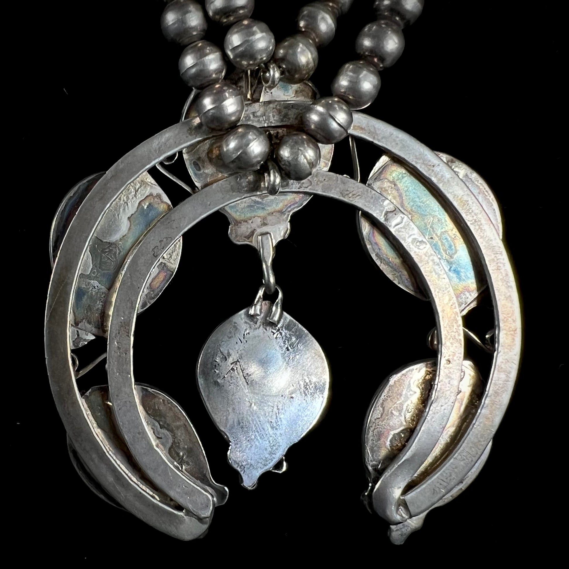 A men's Navajo silver squash blossom necklace set with Kingman turquoise stones.