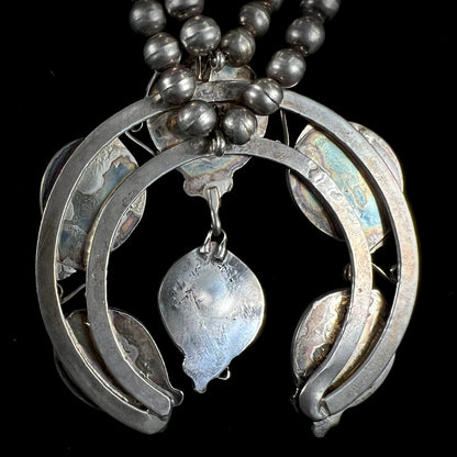 A men's Navajo silver squash blossom necklace set with Kingman turquoise stones.