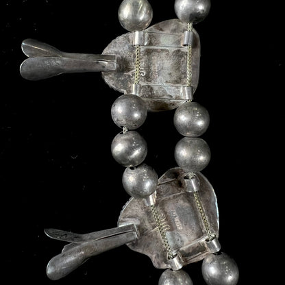 A silver Navajo men's squash blossom necklace set with Fox turquoise and Sonora turquoise.