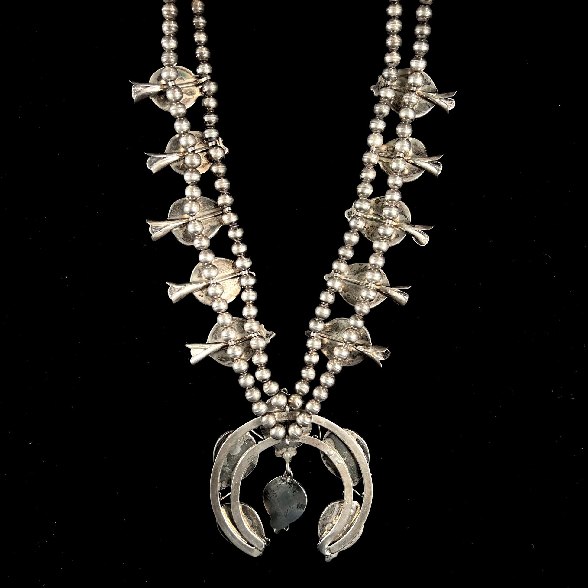 A men's Navajo silver squash blossom necklace set with Kingman turquoise stones.