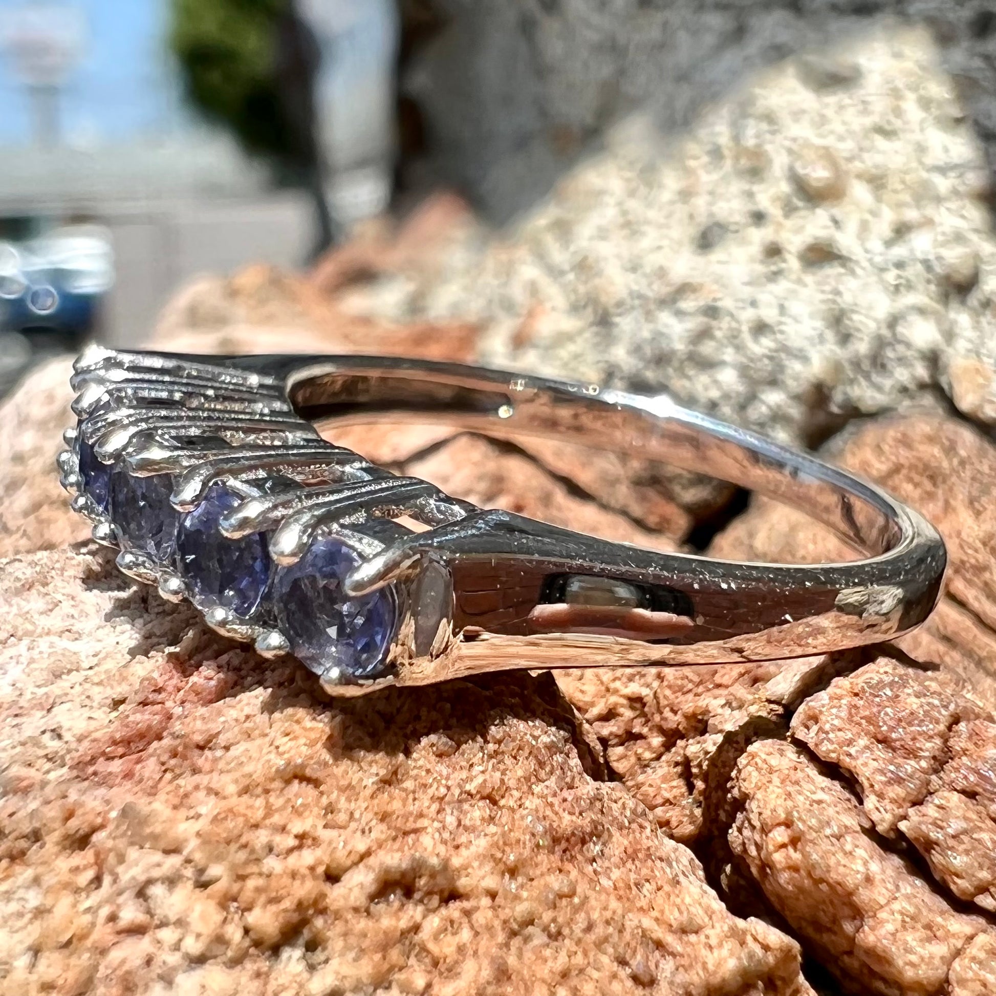 A sterling silver stackable ring set with five Standard Round Brilliant Cut tanzanite stones.