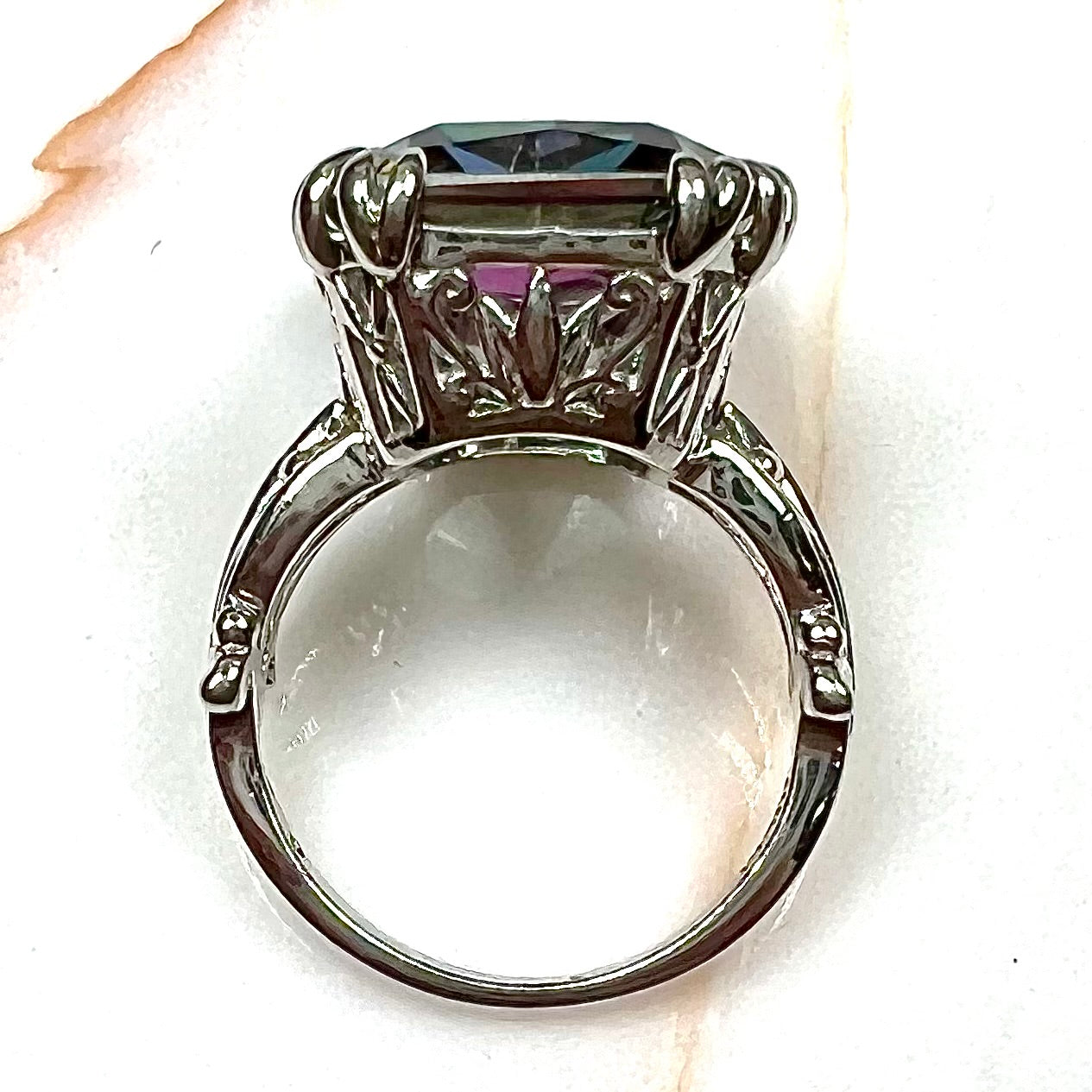 Emerald cut mystic topaz prong set in a decorative sterling silver ring.