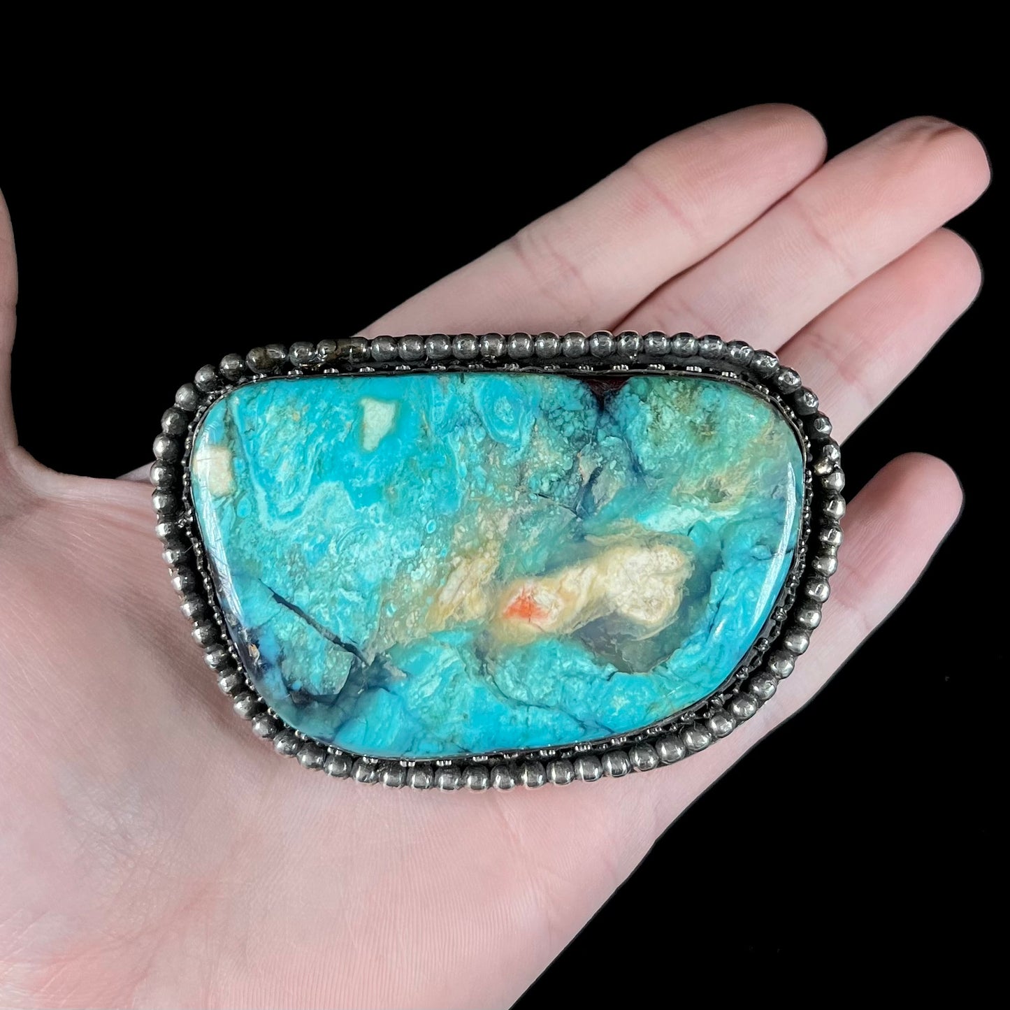 A sterling silver, unisex, Navajo style belt buckle set with a large Valley Blue turquoise stone.