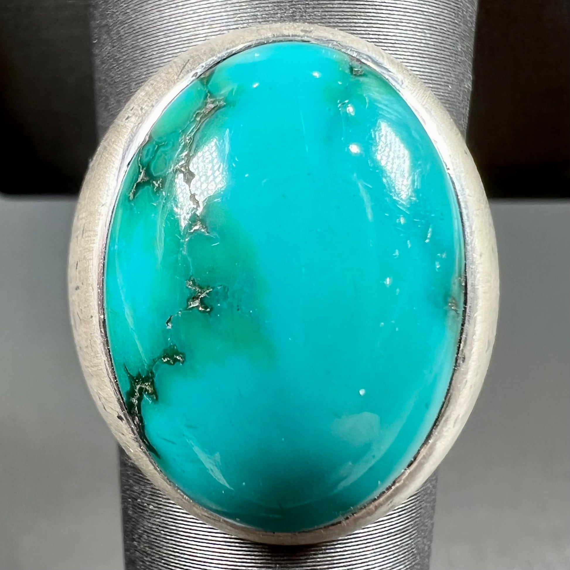 A men's textured silver turquoise solitaire ring.  The turquoise is from Royston Mining District, Nevada.