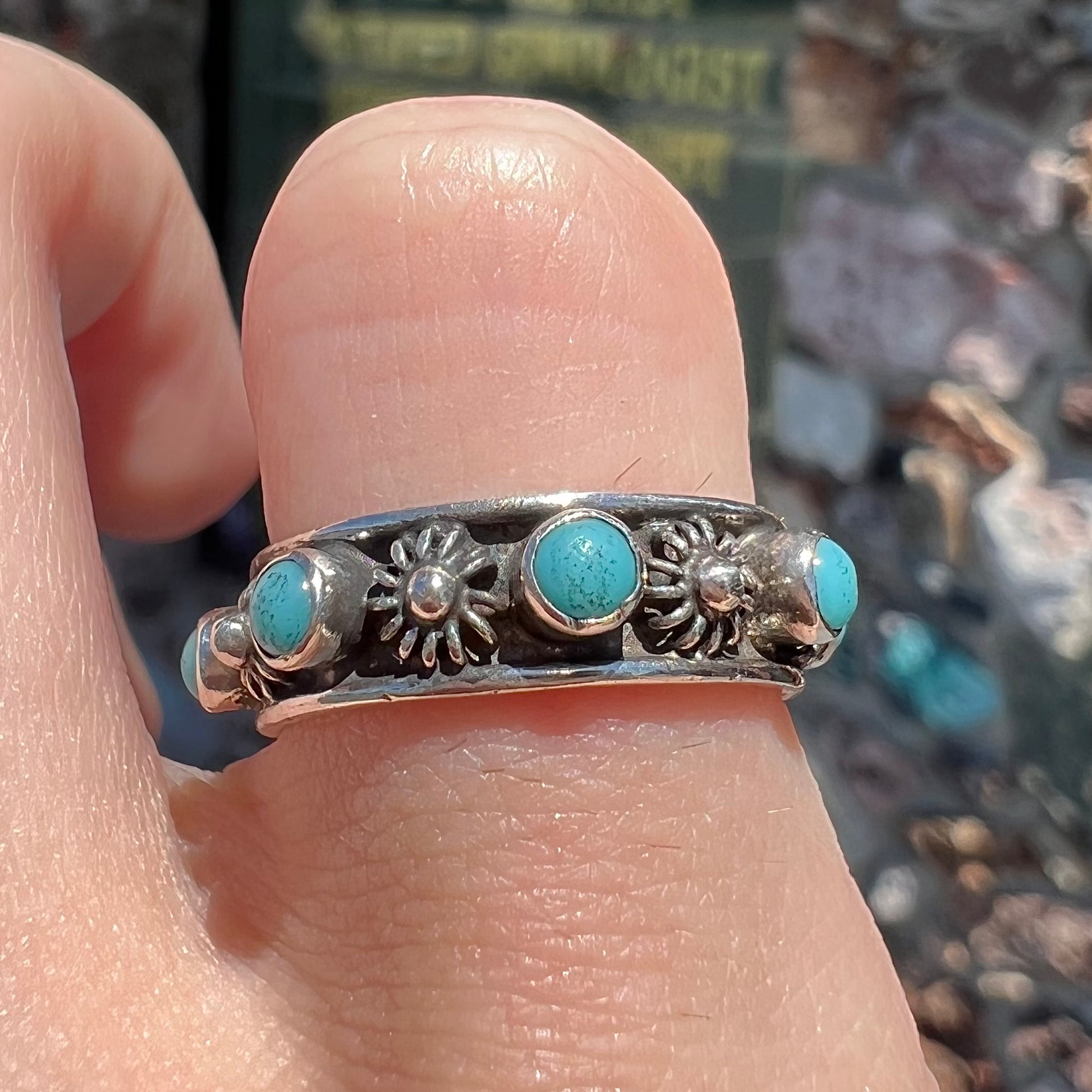 A sterling silver turquoise and flower design eternity band, made in Mexico.