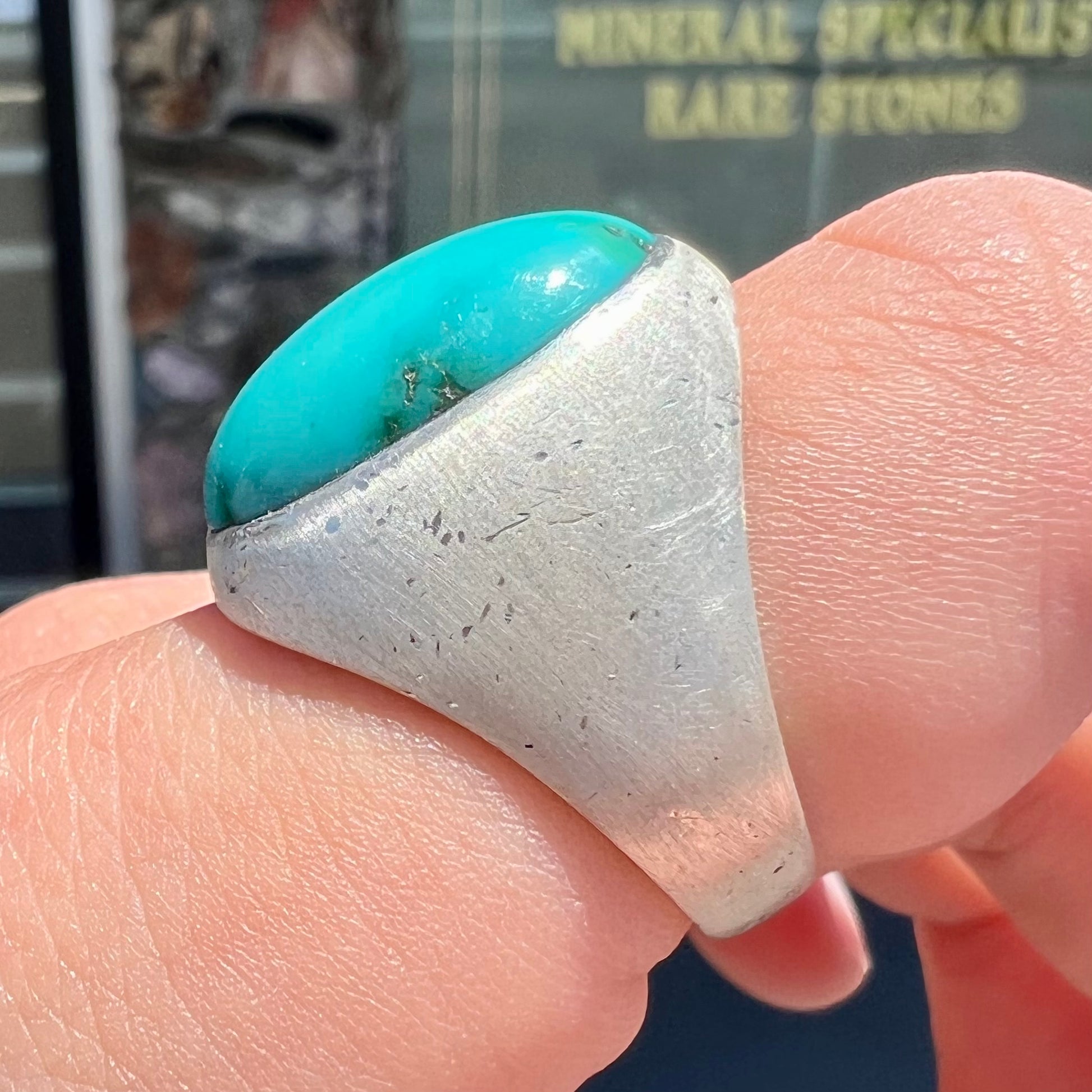 A men's textured silver turquoise solitaire ring.  The turquoise is from Royston Mining District, Nevada.