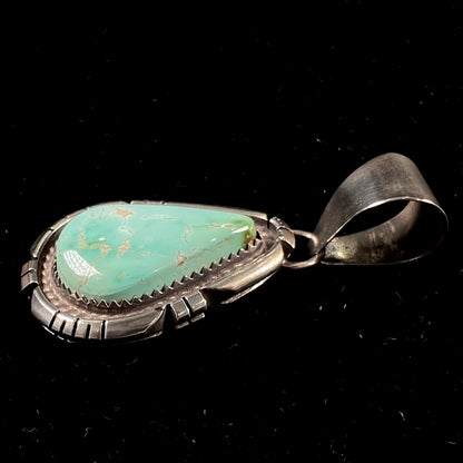 A sterling silver bezel set variscite stone pendant handmade by Navajo artist, Herman Lee.