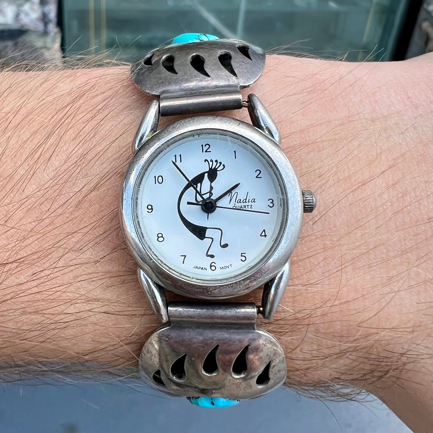 A watch set with two turquoise stones handmade by Navajo artists Arnold and Carleena Goodluck.