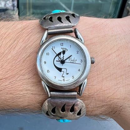 A watch set with two turquoise stones handmade by Navajo artists Arnold and Carleena Goodluck.