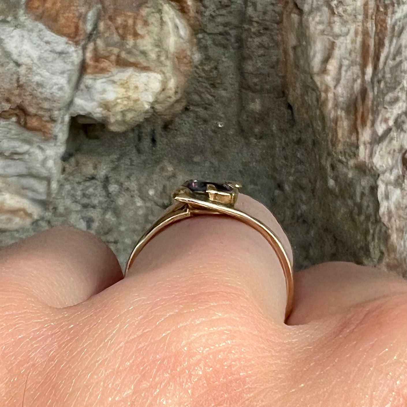 A vintage 1960's yellow gold ring set with a round synthetic purple alexandrite.  The prongs are worn.