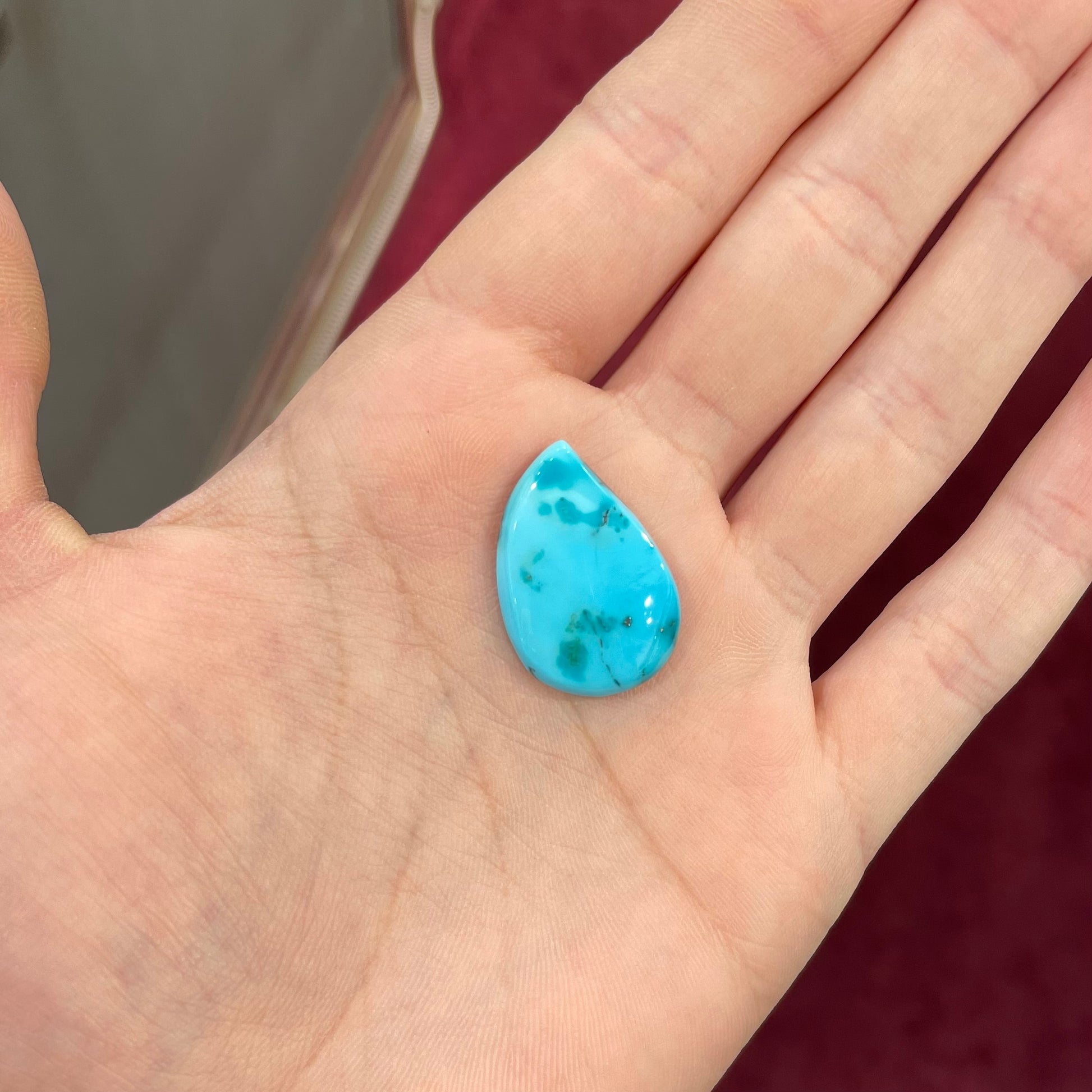 A loose, water drop shaped turquoise stone from the Sleeping Beauty Mine, Arizona.