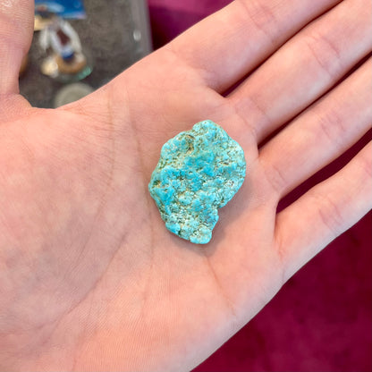 A loose, lightly polished nugget of Sleeping Beauty turquoise.