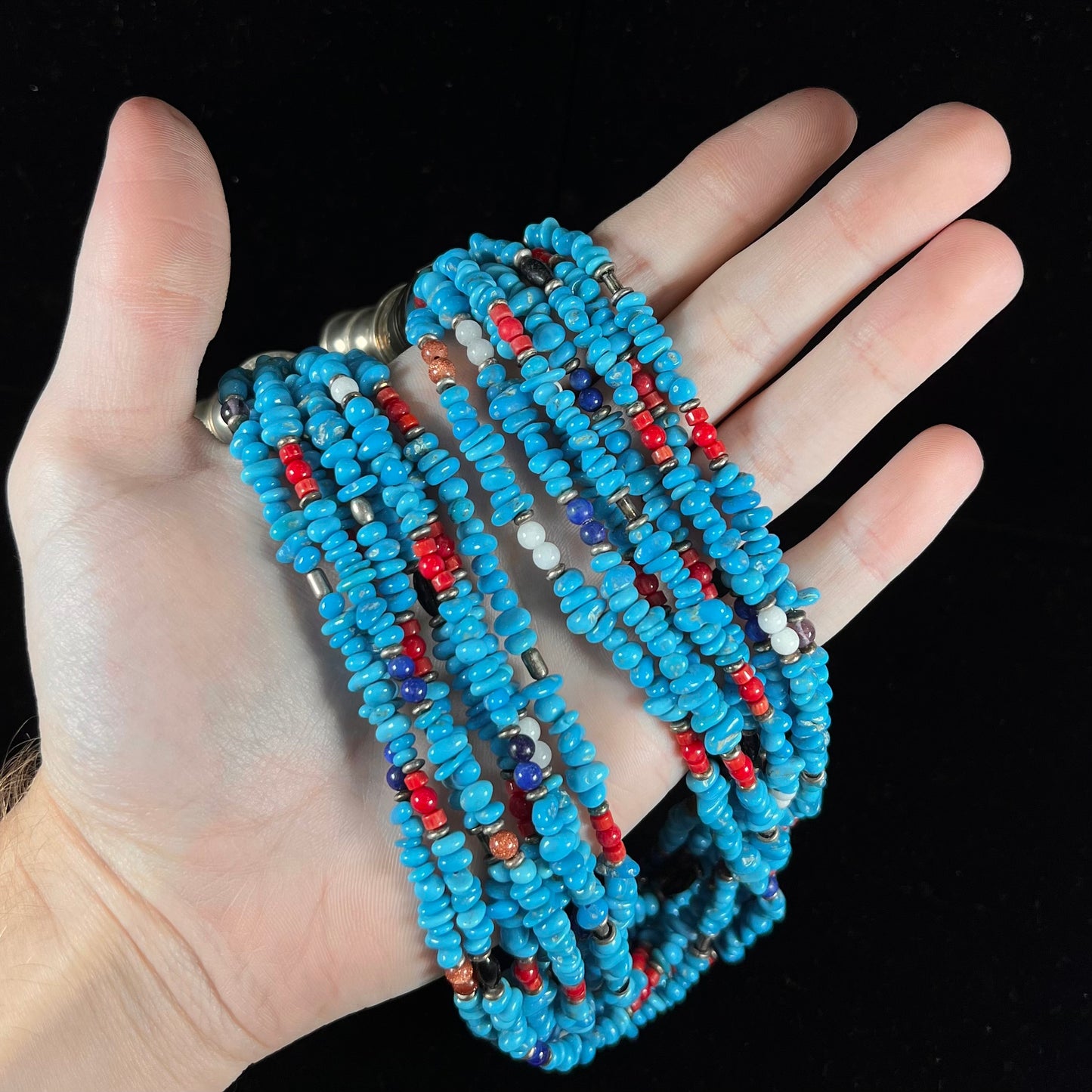 A Navajo Indian-made multistrand Sleeping Beauty turquoise bead necklace with coral, lapis lazuli, goldstone, and onyx accents.