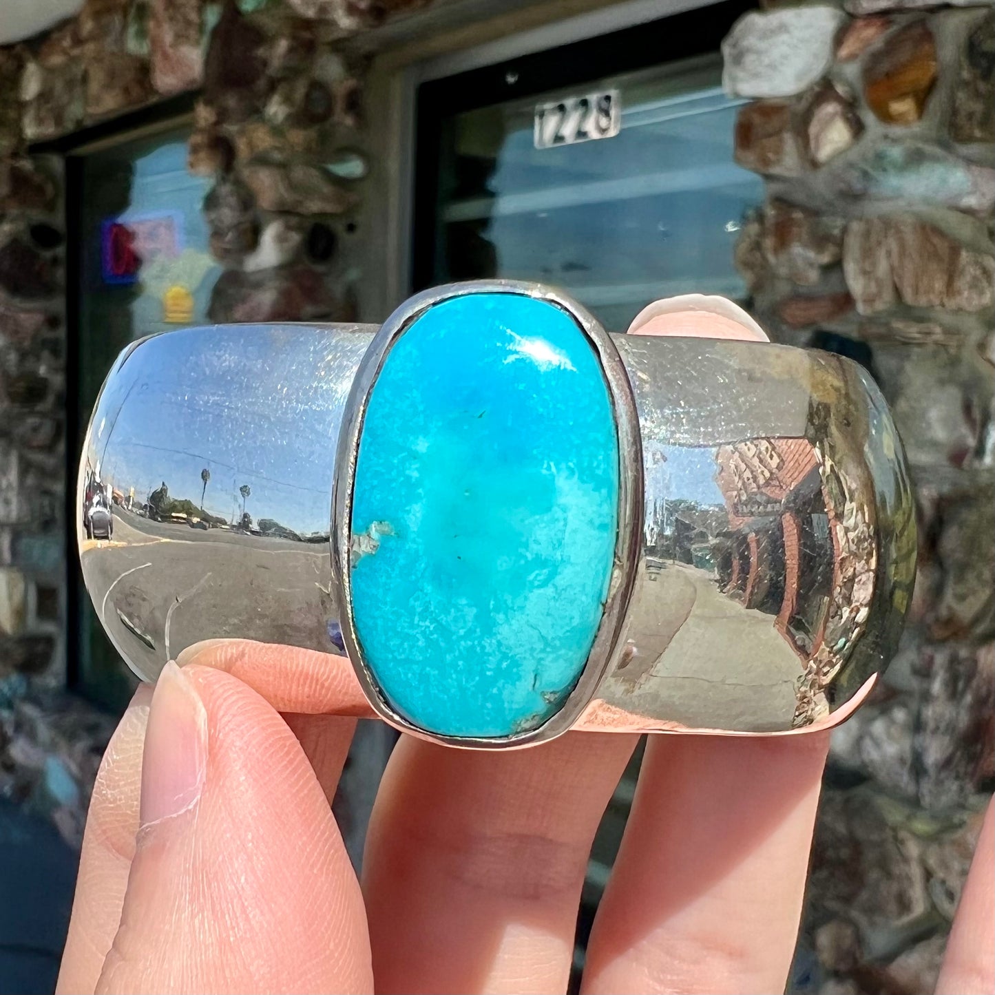 A unisex sterling silver cuff bracelet set with a barrel cabochon cut turquoise from Sleeping Beauty Mine, Arizona.