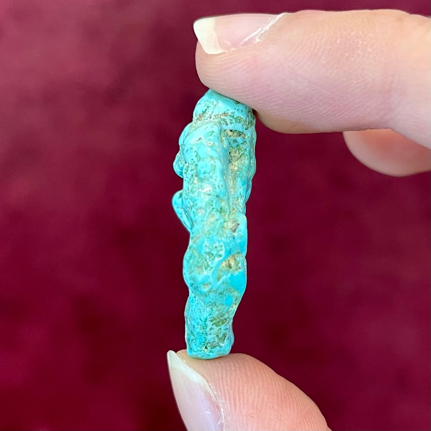 A loose, lightly polished nugget of Sleeping Beauty turquoise.