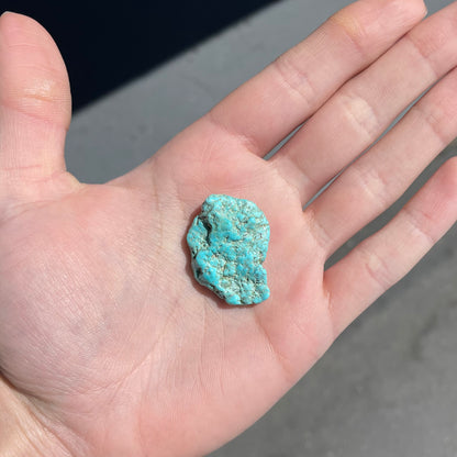 A loose, lightly polished nugget of Sleeping Beauty turquoise.