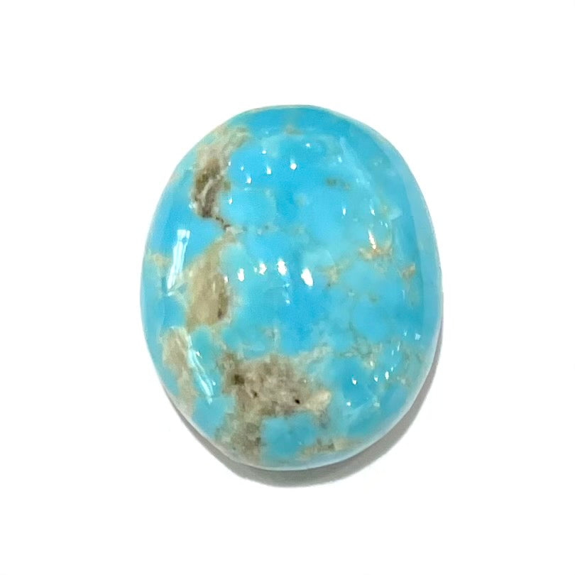A loose, oval cabochon cut turquoise stone from the Sleeping Beauty Mine in Arizona.