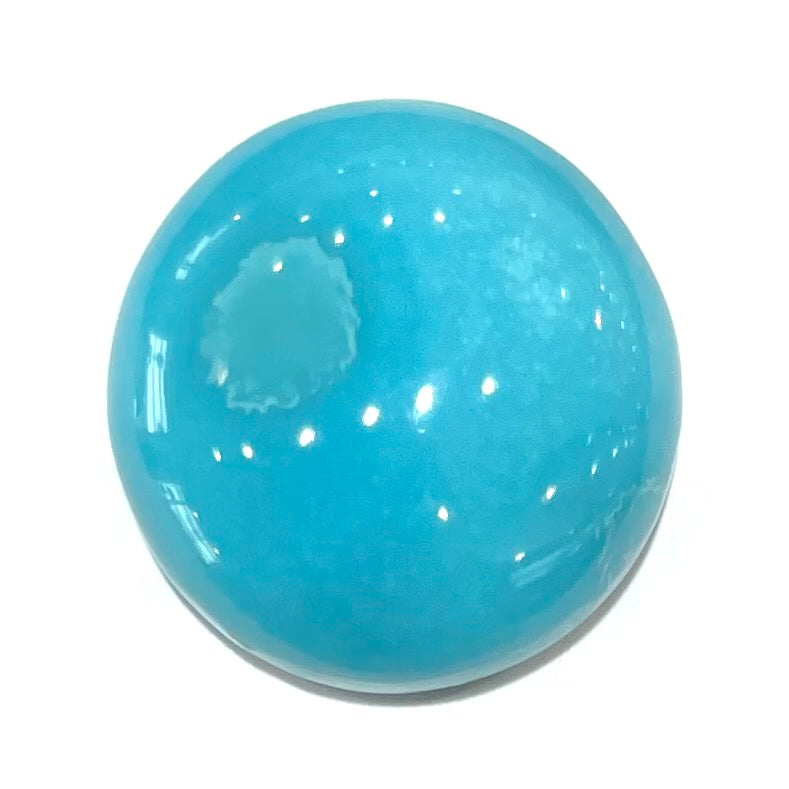 A loose, round cabochon cut turquoise stone from Sleeping Beauty Mine, Arizona.