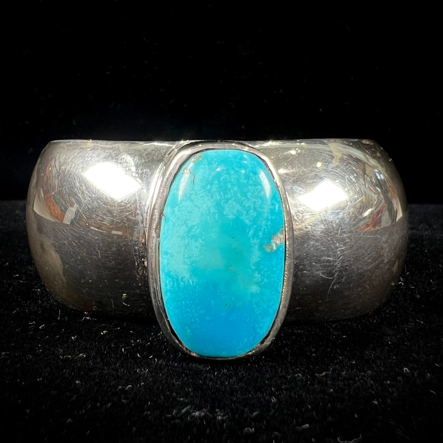 A unisex sterling silver cuff bracelet set with a barrel cabochon cut turquoise from Sleeping Beauty Mine, Arizona.