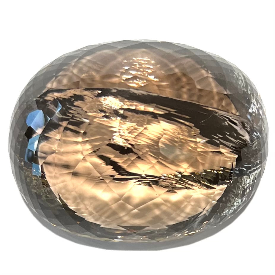 A loose, 1400+ carat smoky quartz gemstone.  The stone has a fracture that runs throughout the stone to the table.