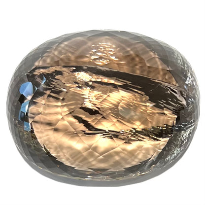 A loose, 1400+ carat smoky quartz gemstone.  The stone has a fracture that runs throughout the stone to the table.