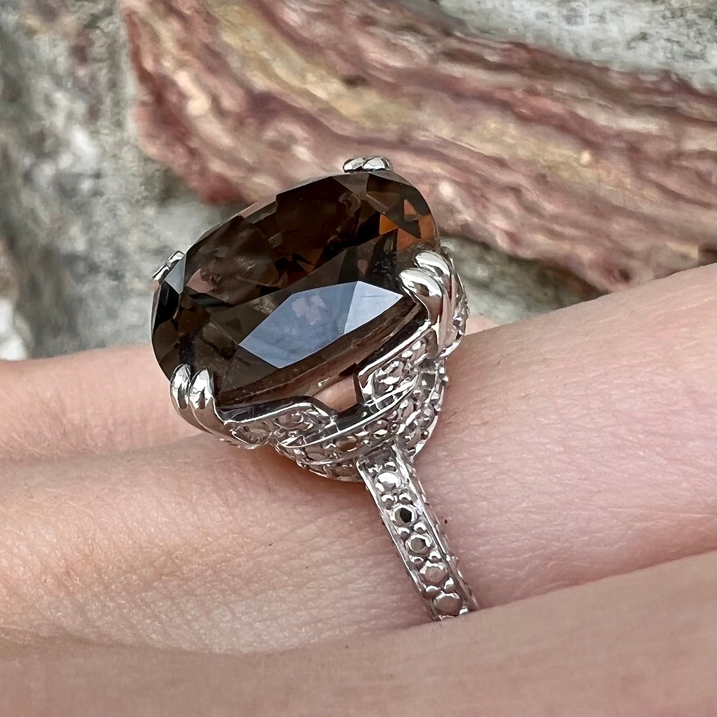 A sterling silver, cushion cut smoky quartz solitaire ring.
